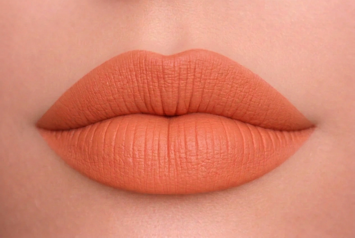 Lips in a midpoint peach-coral orange shade
